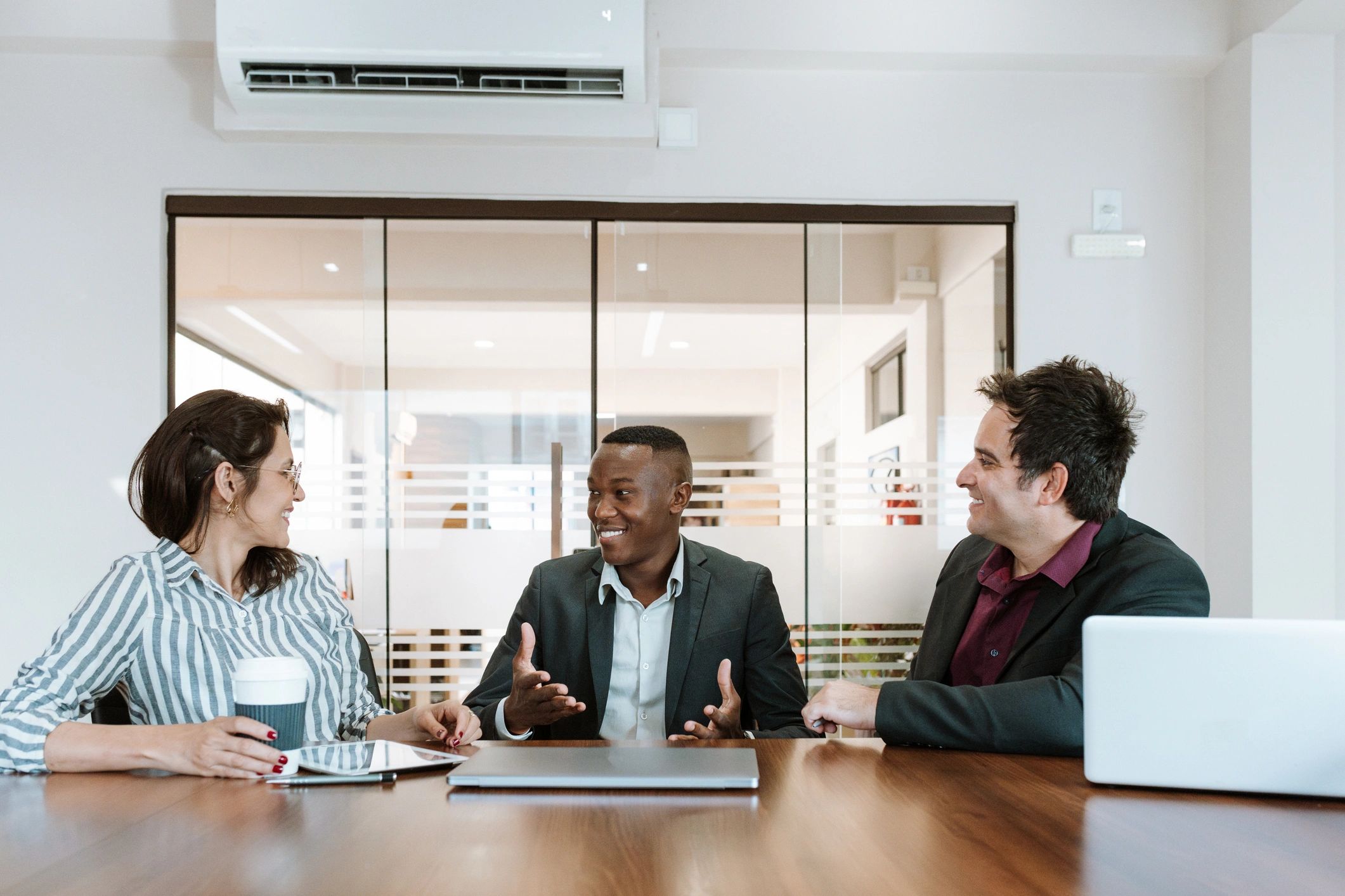Business people having a relaxed conversation in a meeting room